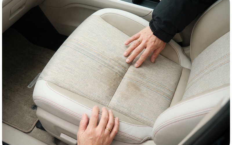 洗浄を終えた運転席のシートまわりに水性シートコーティングを施工しているところ
